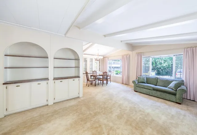 a view of a livingroom with furniture and a window
