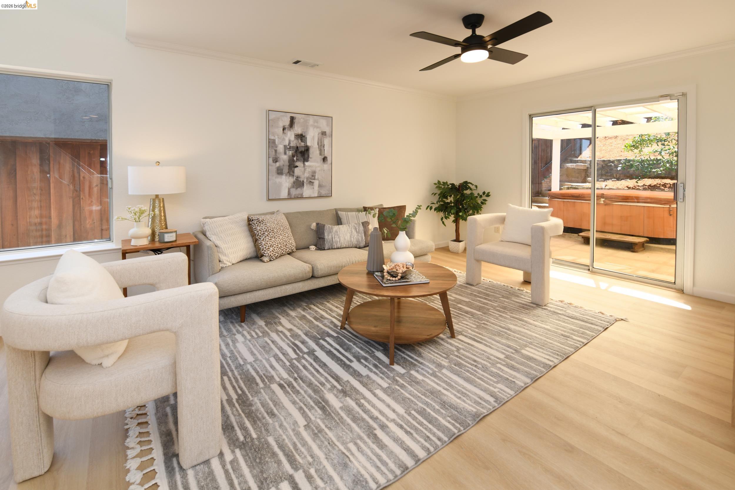 512 Burdick Drive Bay Point, CA 94565 - Photo 22 of 50 Living area featuring wood-finish flooring, a ceiling fan with integrated lighting, and a large window