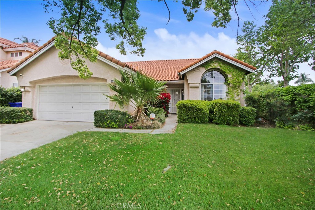 7279 Yarnell Road Highland, CA 92346 - Photo 1 of 1 a front view of a house with a yard and garage