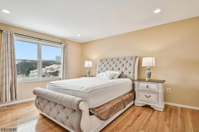 a bedroom with a large bed and a tv on table