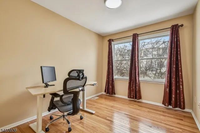 a workspace with wooden floor and a window