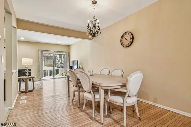 a view of a dining room with furniture wooden floor and a chandelier