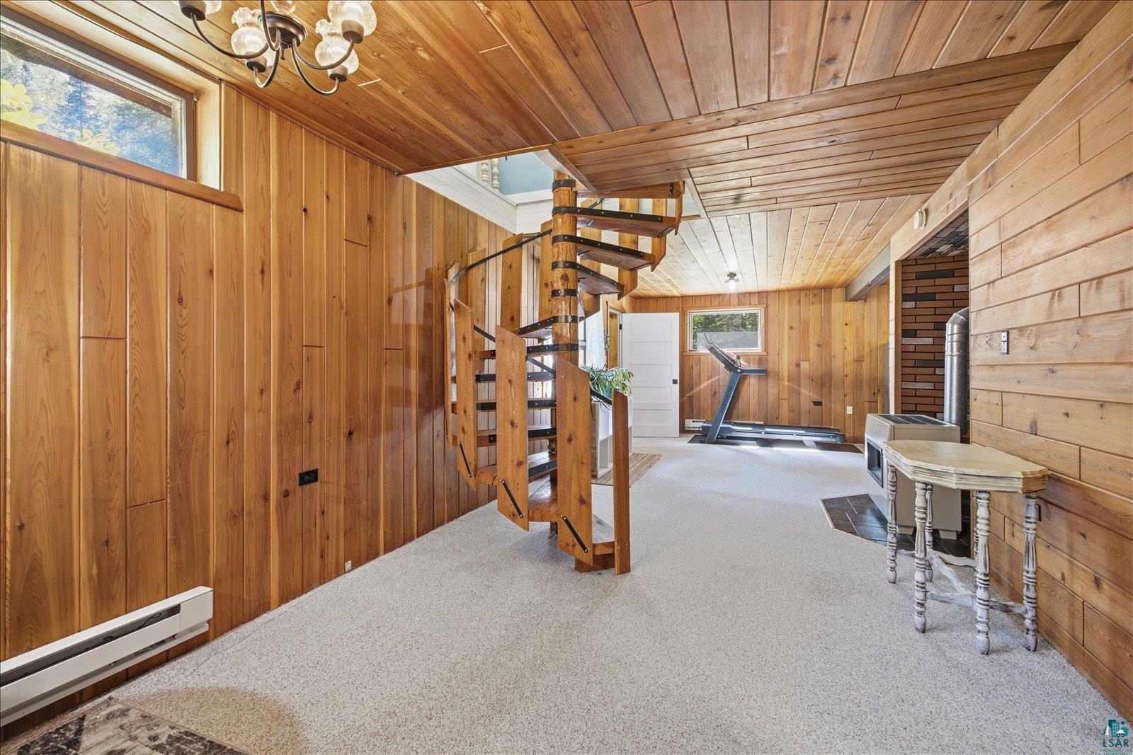 6377 Bergstrom Road Saginaw, MN 55779 - Photo 15 of 20 Spiral staircase featuring wood treads and black metal railing