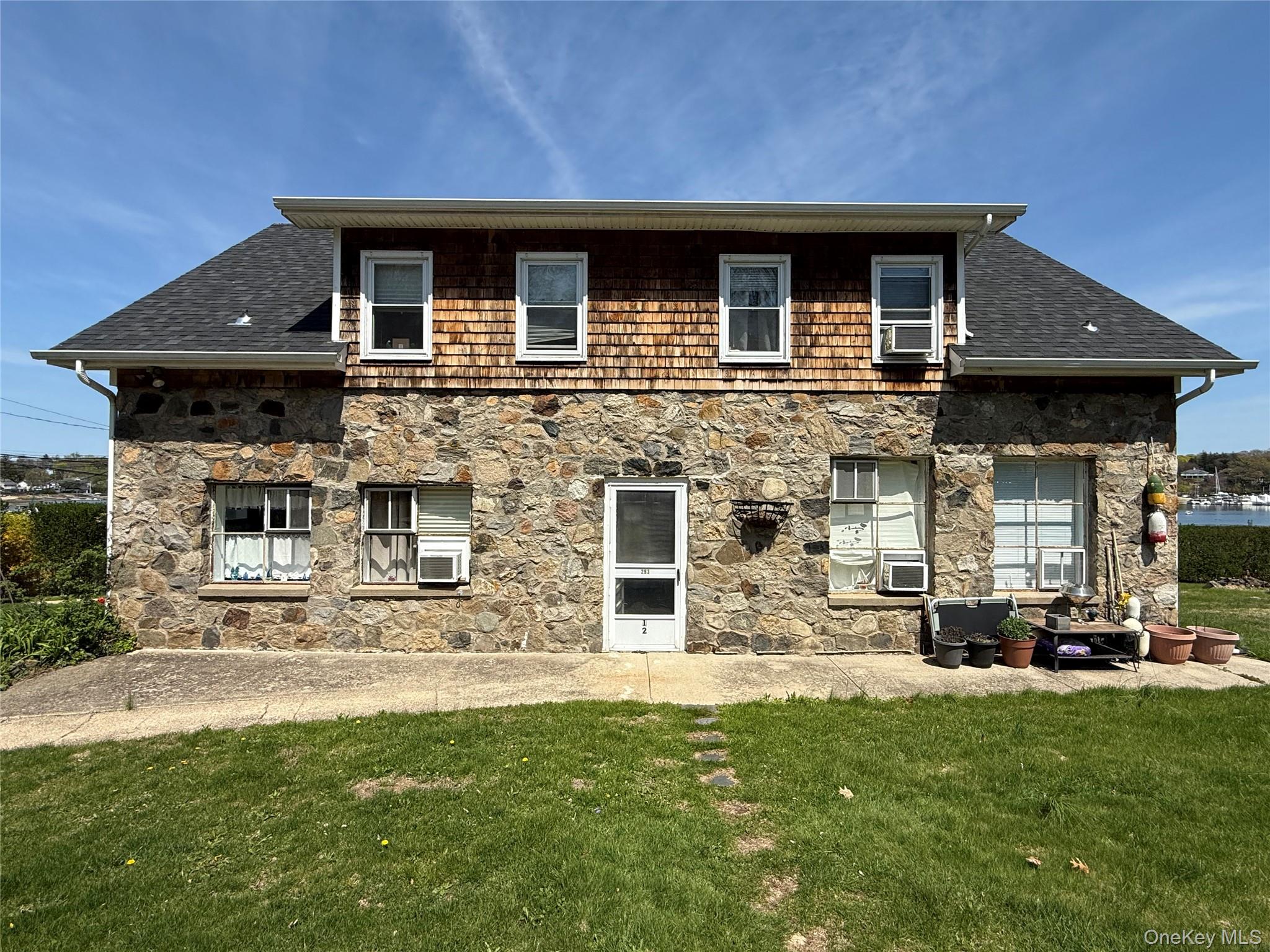 293 West Shore Road, Unit 1 Huntington, NY 11743 - Photo 12 of 13 a front view of a house with a garden