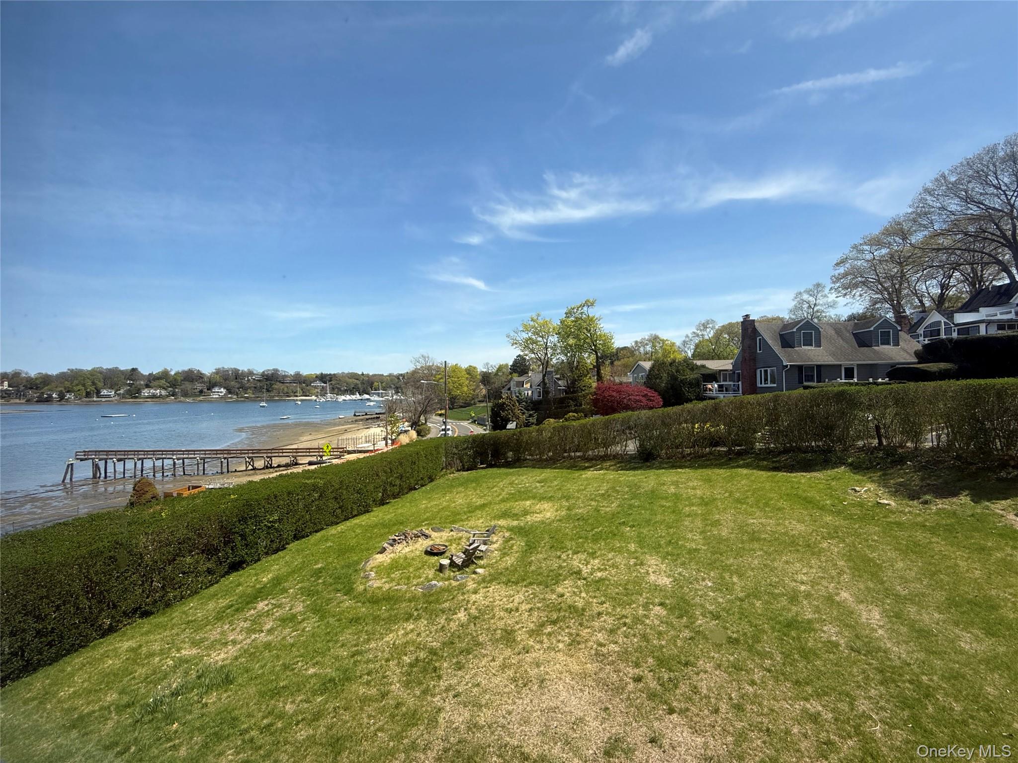 293 West Shore Road, Unit 1 Huntington, NY 11743 - Photo 2 of 13 a view of a lake with houses in the back