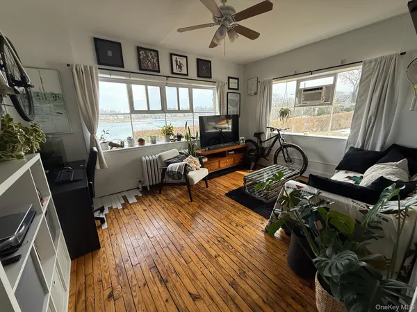 a living room with furniture window and wooden floor