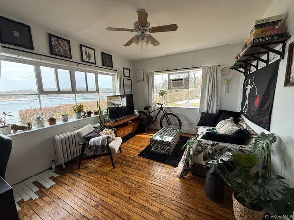 a living room with furniture and a floor to ceiling window