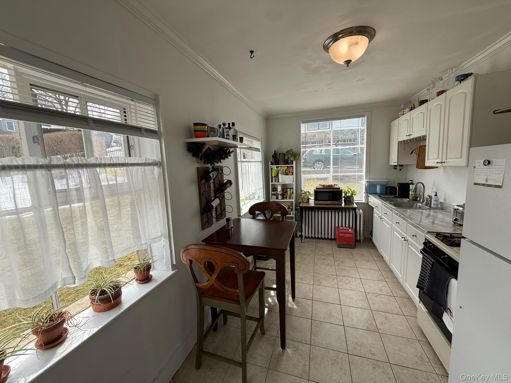 293 West Shore Road, Unit 1 Huntington, NY 11743 - Photo 7 of 13 a kitchen with a window a sink and a refrigerator