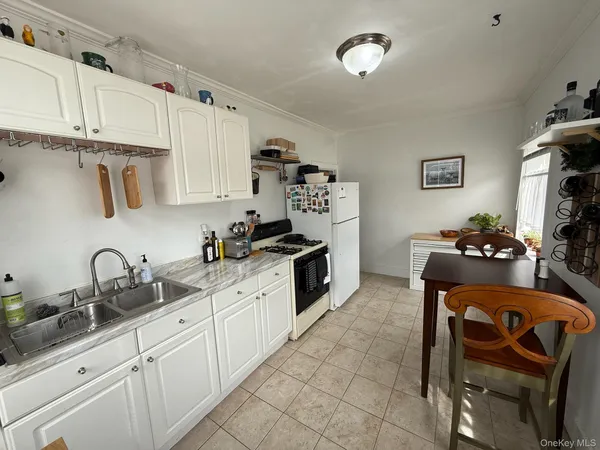 a kitchen with granite countertop a sink cabinets and appliances