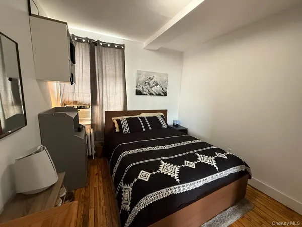 a bedroom with a bed and window