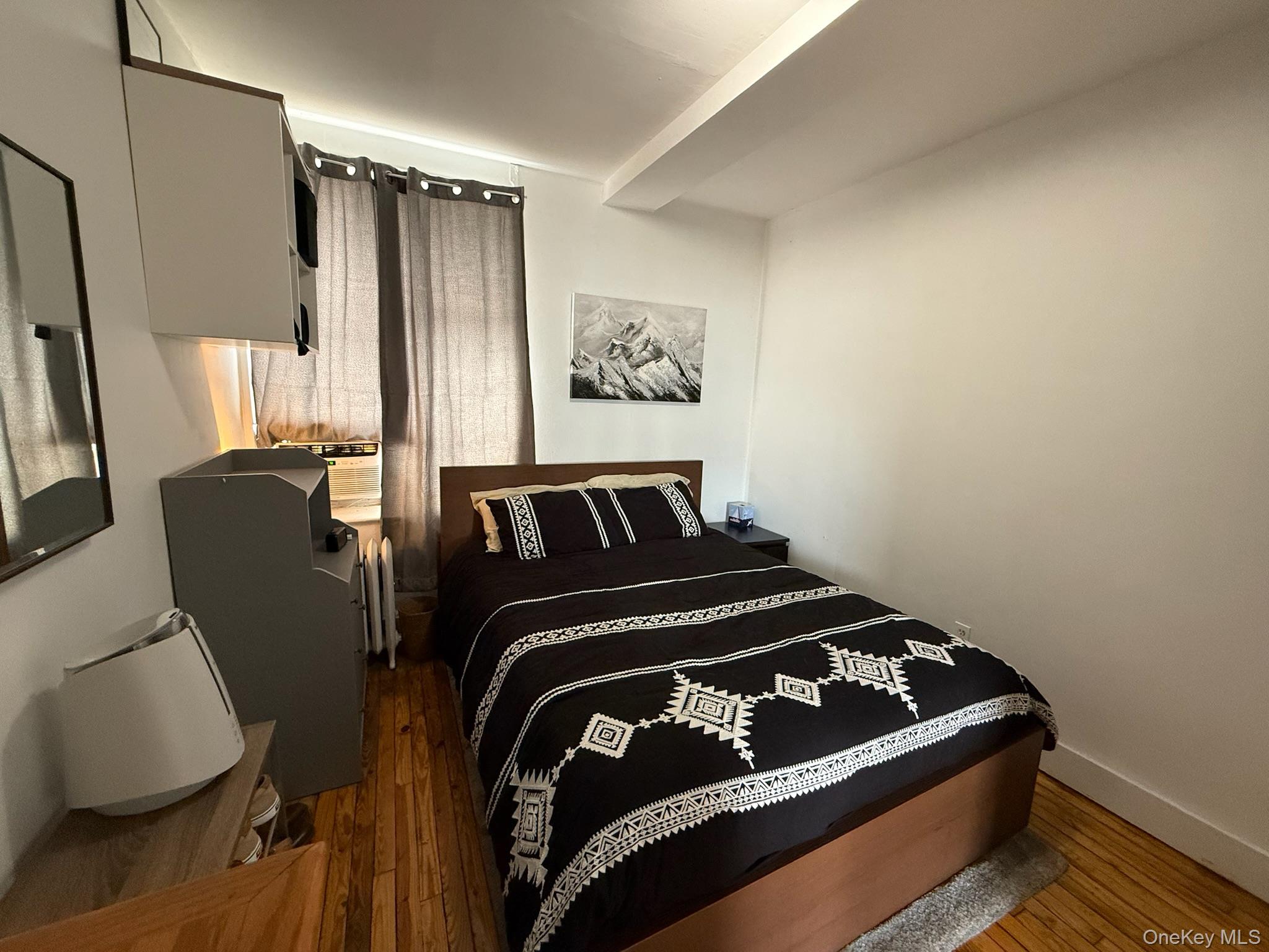 293 West Shore Road, Unit 1 Huntington, NY 11743 - Photo 10 of 13 a bedroom with a bed and window