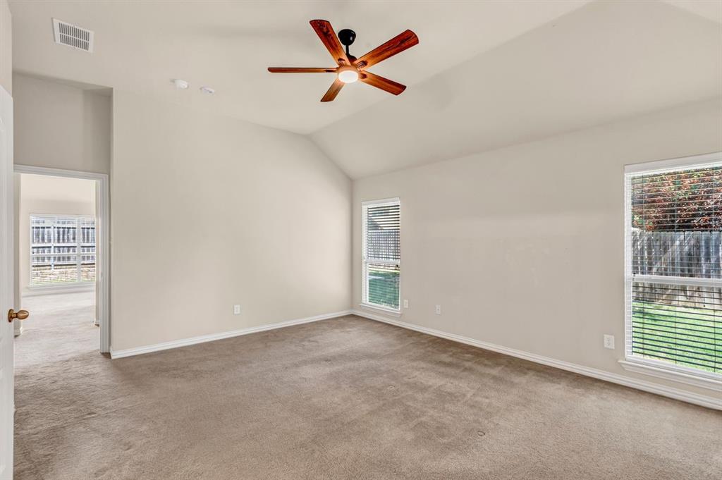 5316 Ridgeson Drive McKinney, TX 75071 - Photo 22 of 33 Carpeted room with vaulted ceiling and a wood-finish ceiling fan