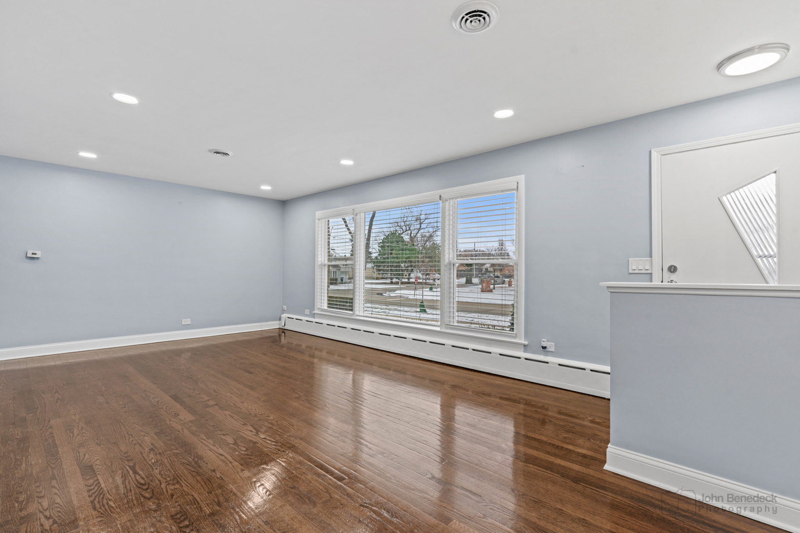2170 Douglas Avenue Des Plaines, IL 60018 - Photo 5 of 21 a view of an empty room with wooden floor and a window