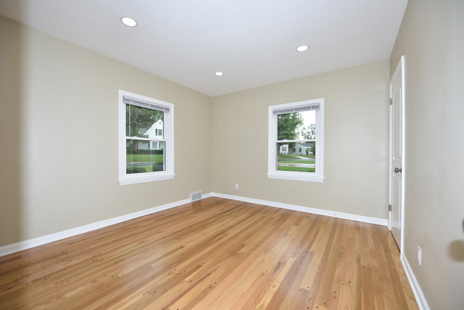 502 Manchester Road Normal, IL 61761 - Photo 13 of 29 a view of empty room with wooden floor and fan