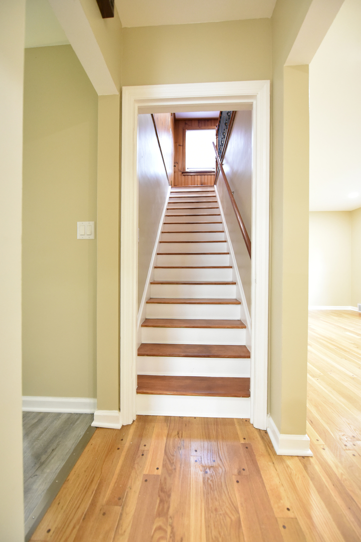 502 Manchester Road Normal, IL 61761 - Photo 14 of 29 a view of a hallway with wooden floor and staircase