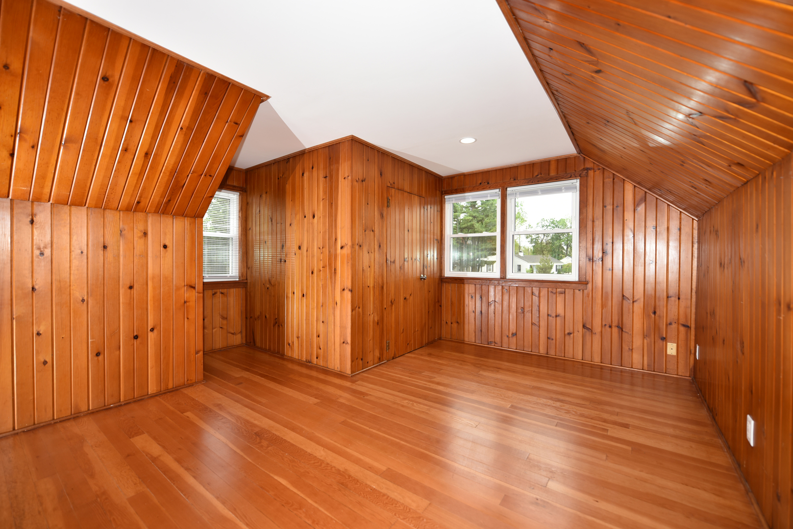 502 Manchester Road Normal, IL 61761 - Photo 16 of 29 an empty room with wooden floor and windows with curtains