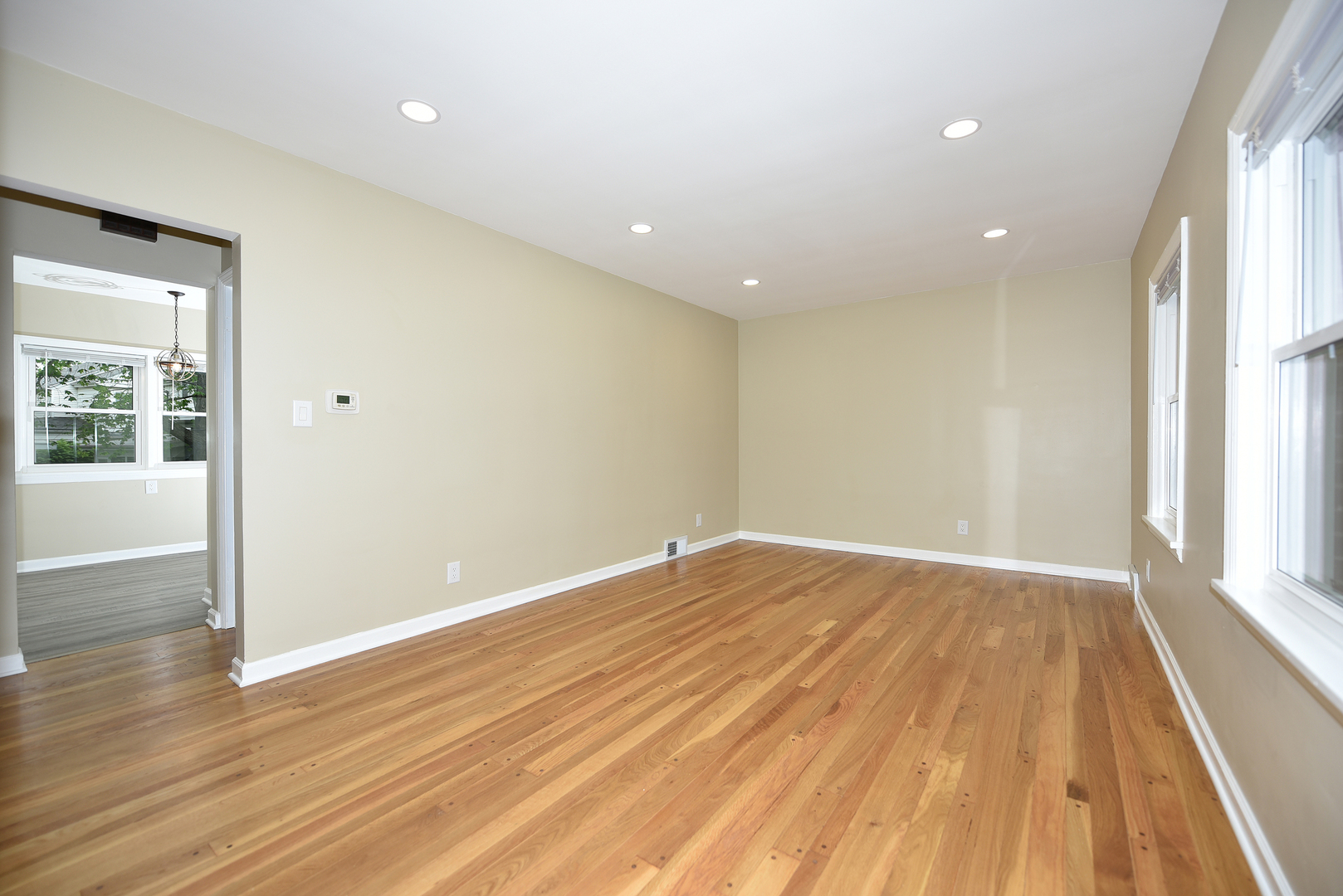 502 Manchester Road Normal, IL 61761 - Photo 4 of 29 an empty room with wooden floor and windows