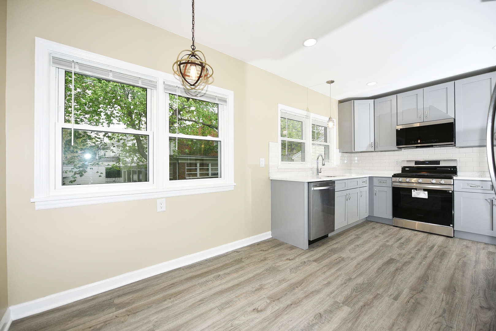 502 Manchester Road Normal, IL 61761 - Photo 6 of 29 a kitchen with a stove a sink and a window