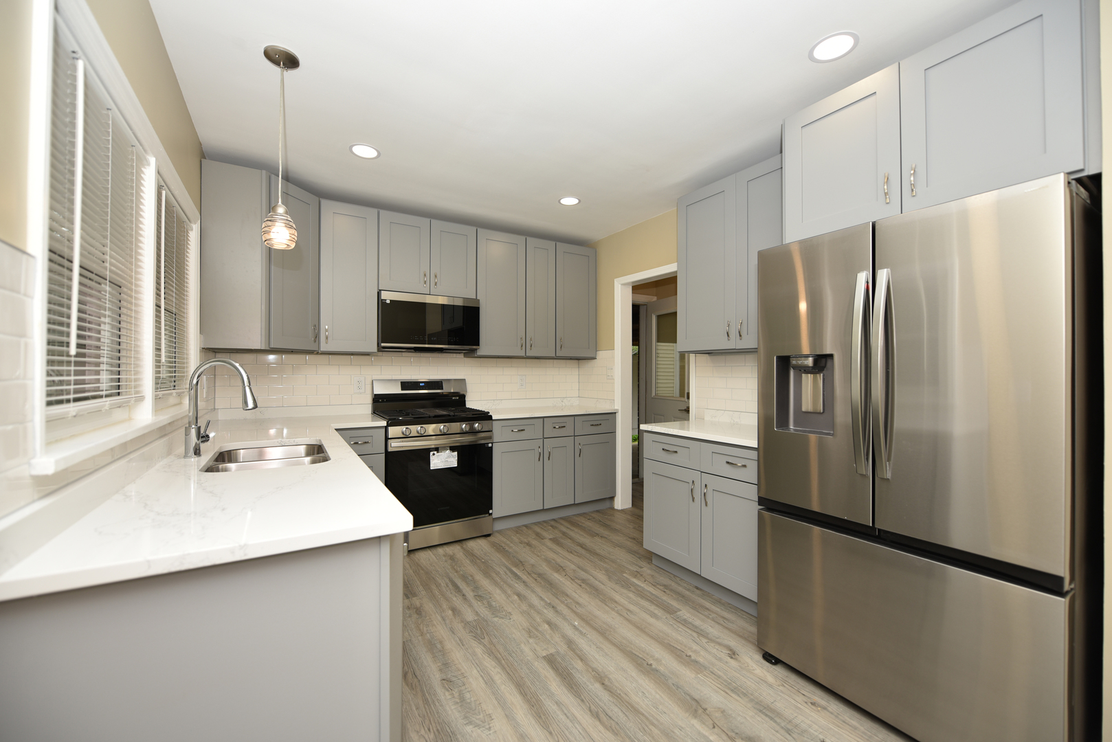 502 Manchester Road Normal, IL 61761 - Photo 8 of 29 a kitchen with a refrigerator a sink and a microwave