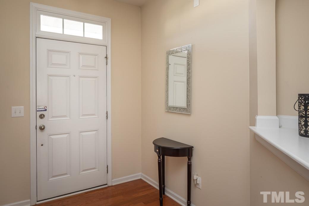 1345 Still Monument Way Raleigh, NC 27603 - Photo 2 of 28 a view of a hallway with front door and wooden floor