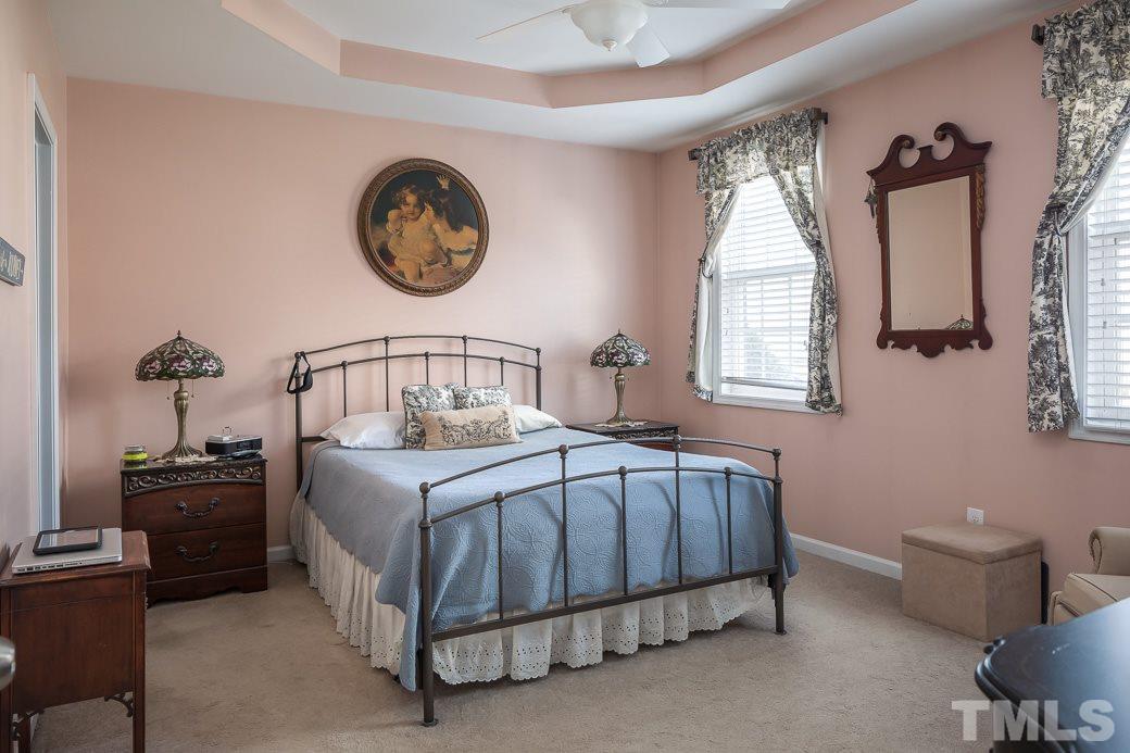 1345 Still Monument Way Raleigh, NC 27603 - Photo 14 of 28 a bedroom with a bed a dresser and window