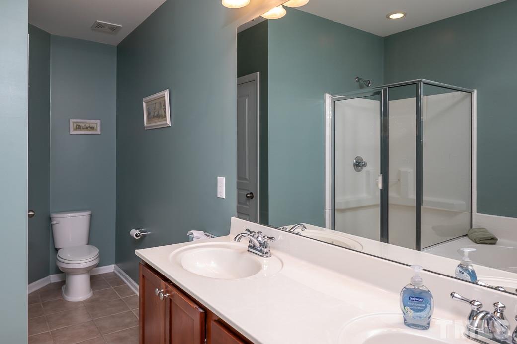 1345 Still Monument Way Raleigh, NC 27603 - Photo 16 of 28 a bathroom with a sink toilet and shower