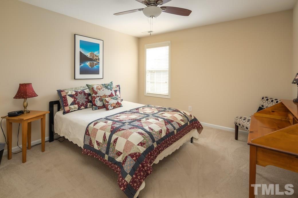 1345 Still Monument Way Raleigh, NC 27603 - Photo 19 of 28 a bedroom with a bed and a chandelier