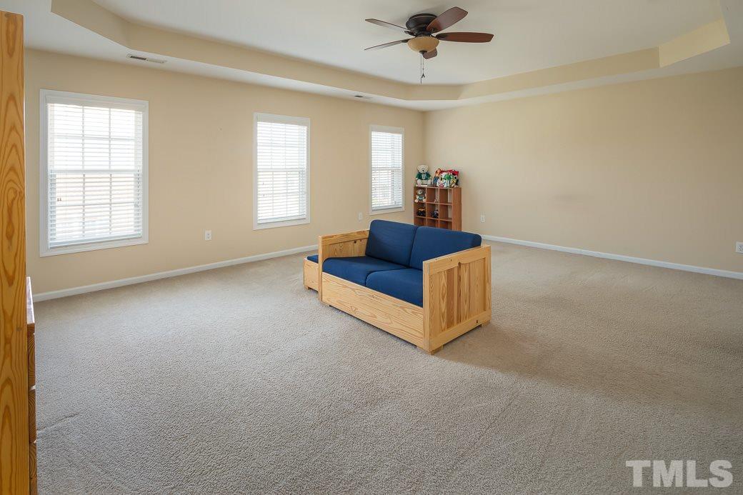 1345 Still Monument Way Raleigh, NC 27603 - Photo 21 of 28 a living room with furniture and a ceiling fan
