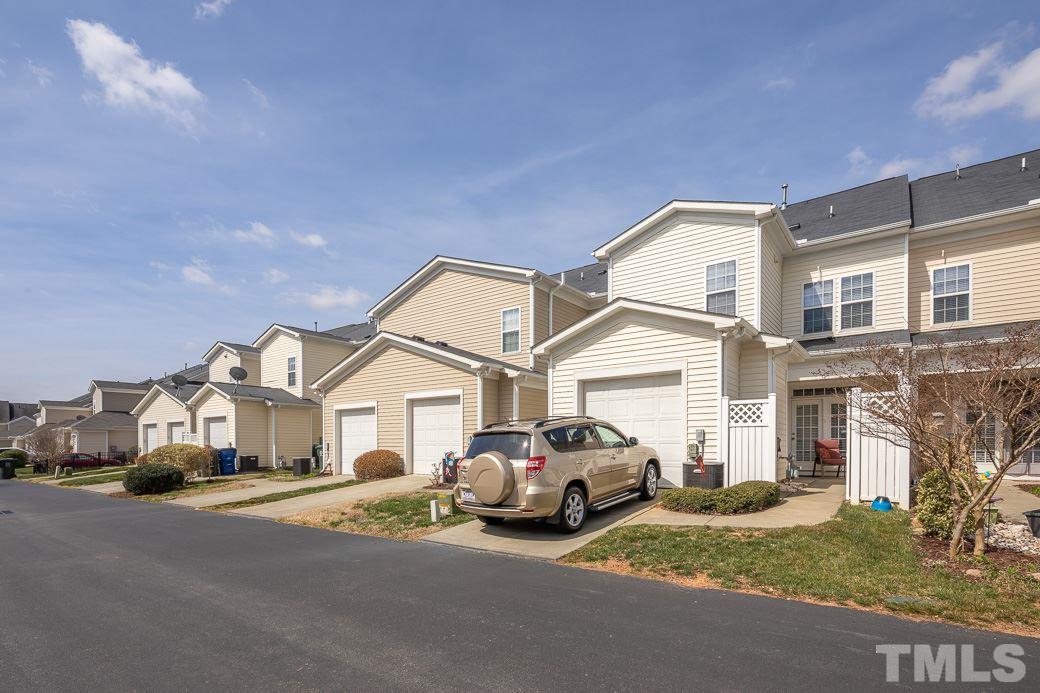 1345 Still Monument Way Raleigh, NC 27603 - Photo 23 of 28 a white house that has a street sign and a car parked in front of it