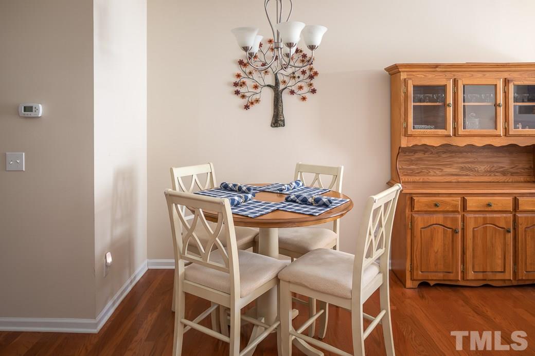 1345 Still Monument Way Raleigh, NC 27603 - Photo 4 of 28 a view of a dining room with furniture and chandelier