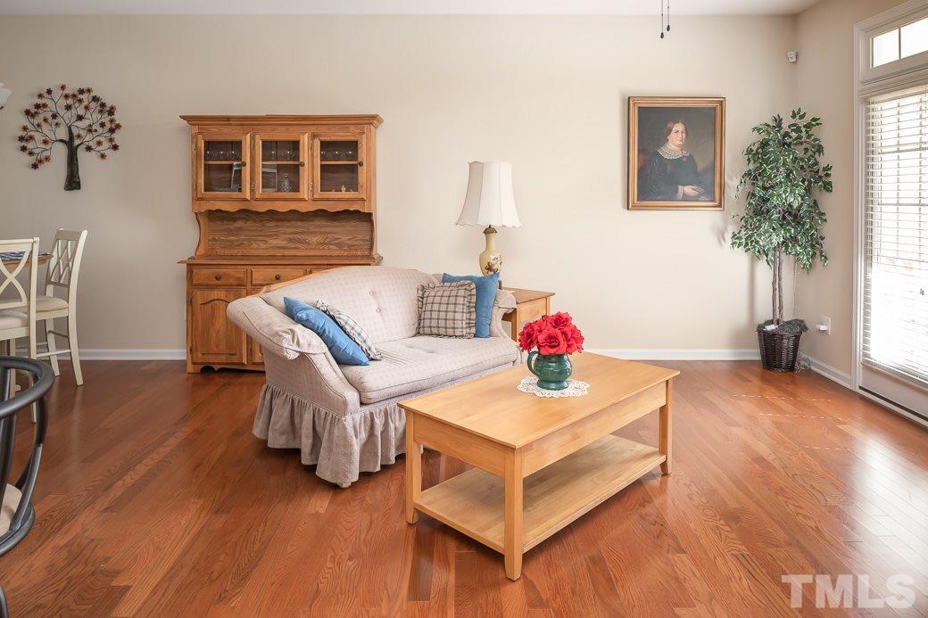 1345 Still Monument Way Raleigh, NC 27603 - Photo 10 of 28 a living room with furniture and wooden floor