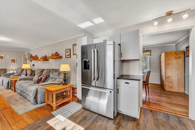 a kitchen with stainless steel appliances a refrigerator and wooden floor