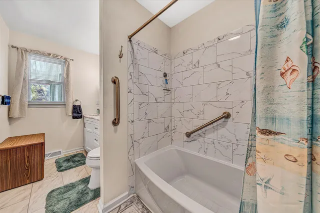 a bathroom with a bathtub and a shower