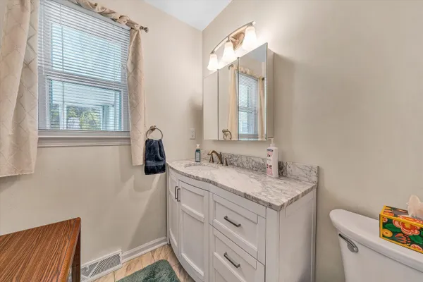 a bathroom with a sink a vanity and a mirror