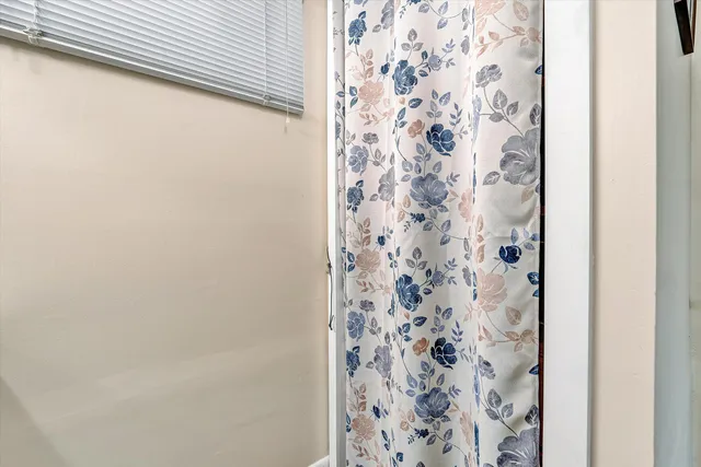 a view of a livingroom with an empty space and a fireplace