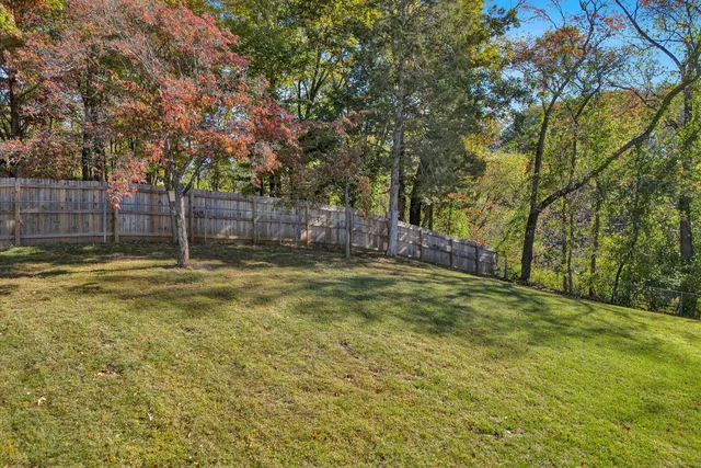 an aerial view of a house with swimming pool garden and patio
