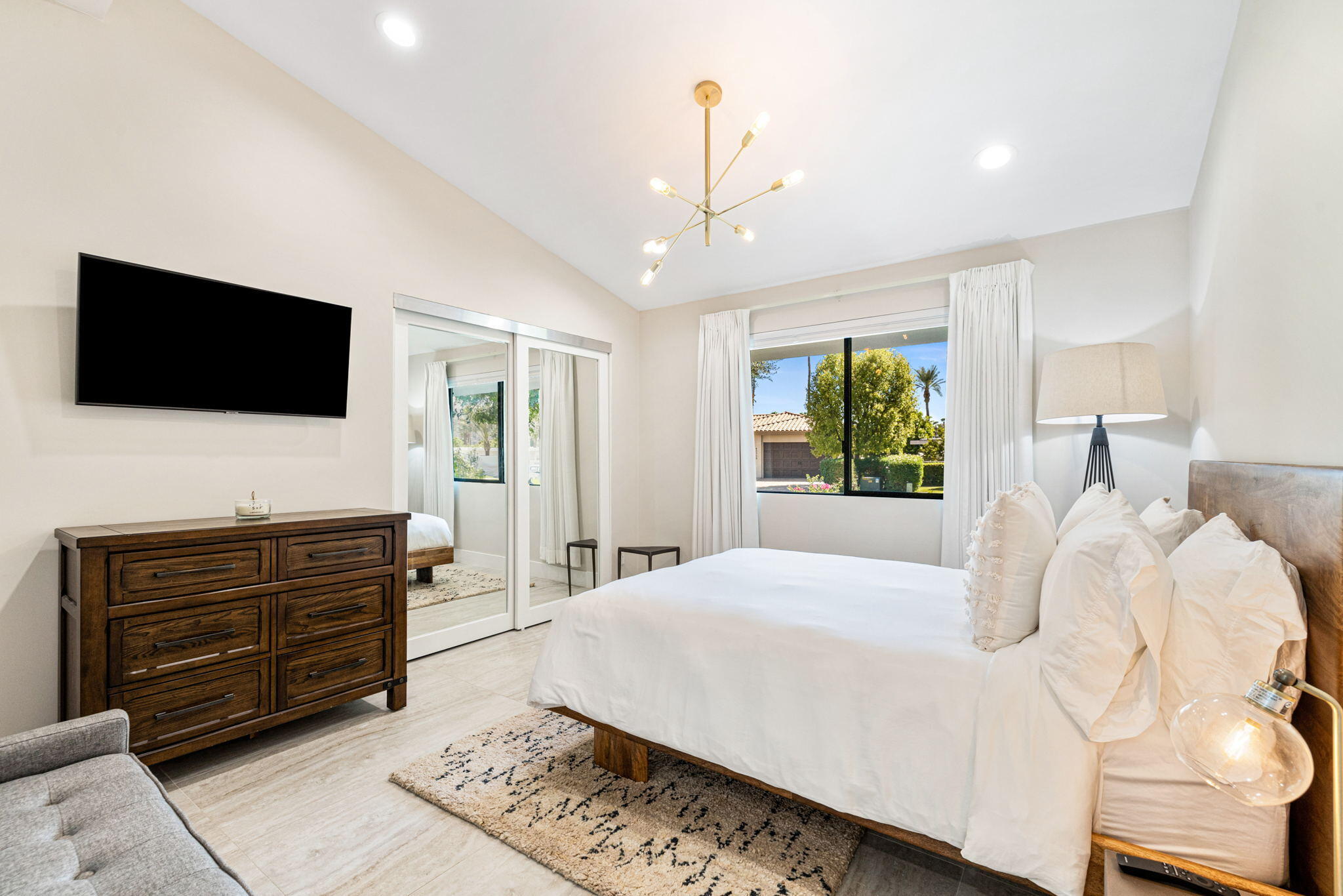 45655 Apache Road, Unit E Indian Wells, CA 92210 - Photo 20 of 31 a bedroom with a large bed and a flat screen tv
