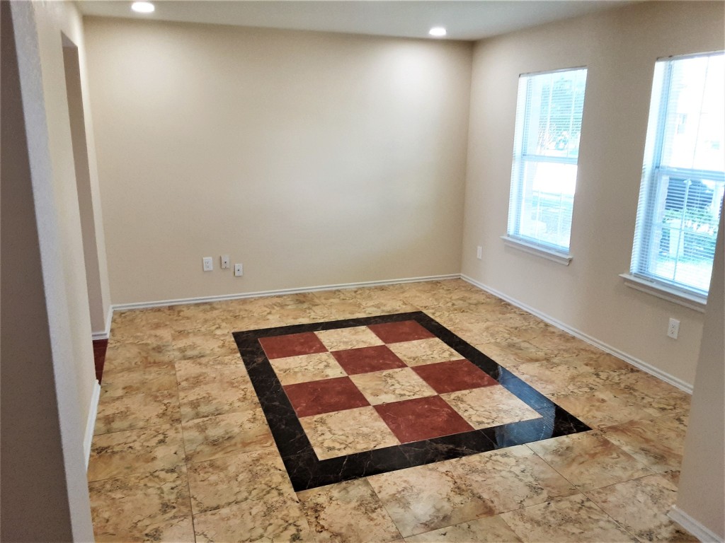205 Rinehardt Street Hutto, TX 78634 - Photo 13 of 40 an empty room with windows