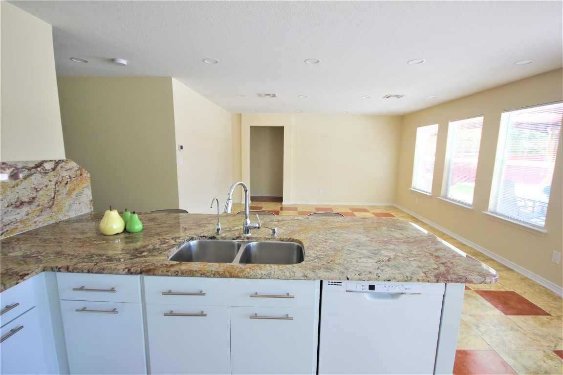 205 Rinehardt Street Hutto, TX 78634 - Photo 17 of 40 a bathroom with a granite countertop sink and a large mirror