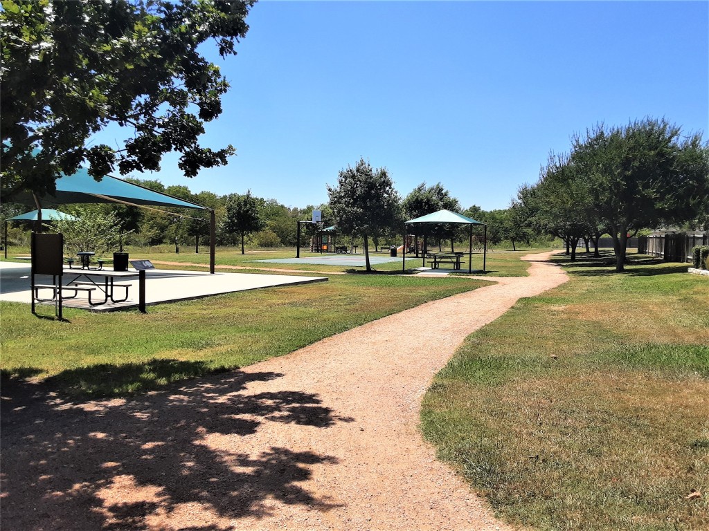 205 Rinehardt Street Hutto, TX 78634 - Photo 22 of 40 a view of a park with swings and slides