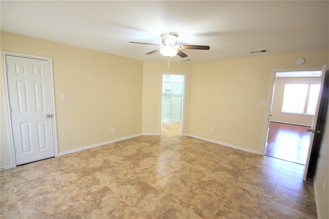205 Rinehardt Street Hutto, TX 78634 - Photo 27 of 40 a view of an empty room with a chandelier fan