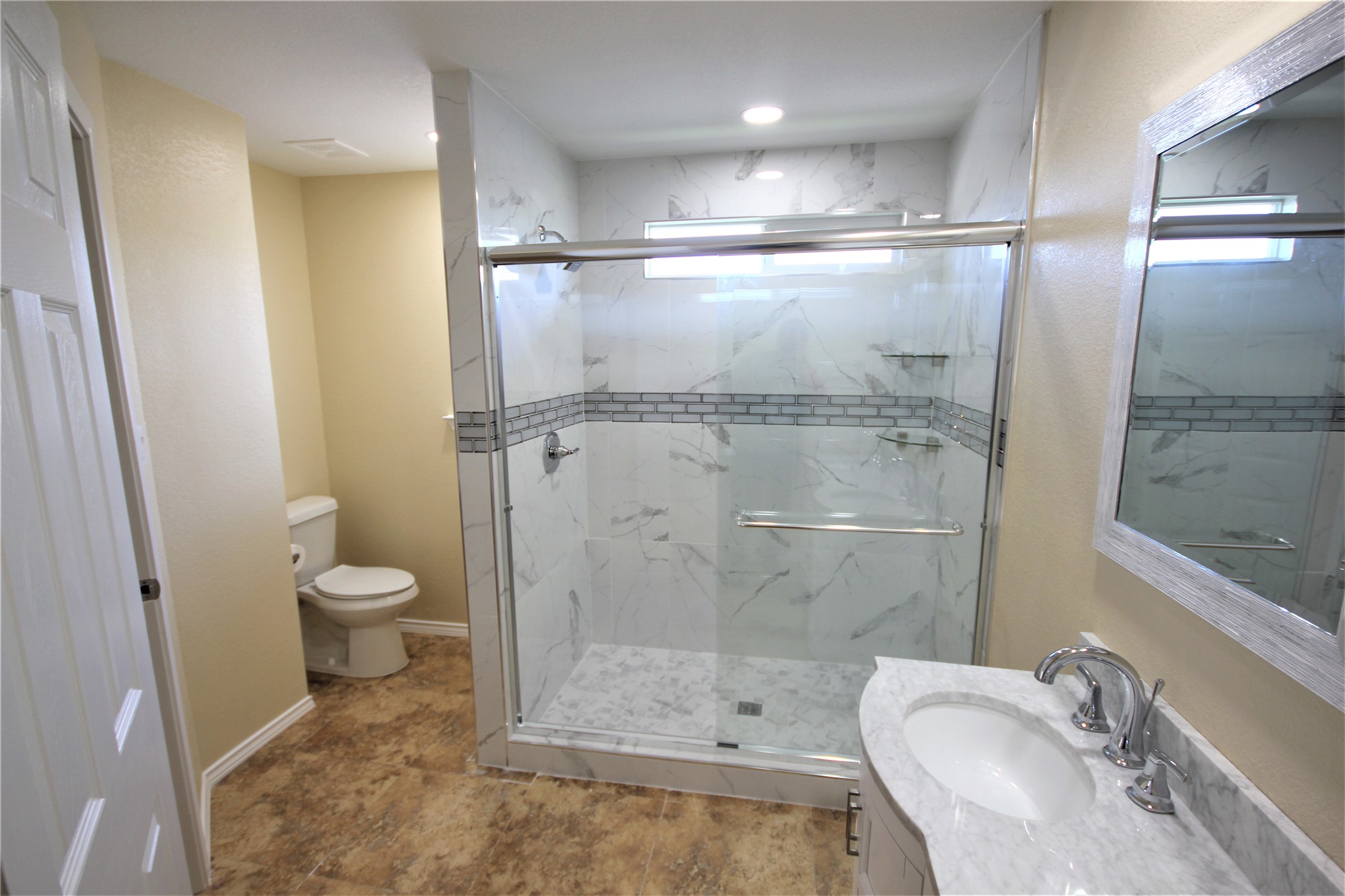 205 Rinehardt Street Hutto, TX 78634 - Photo 29 of 40 a bathroom with a granite countertop sink toilet and shower