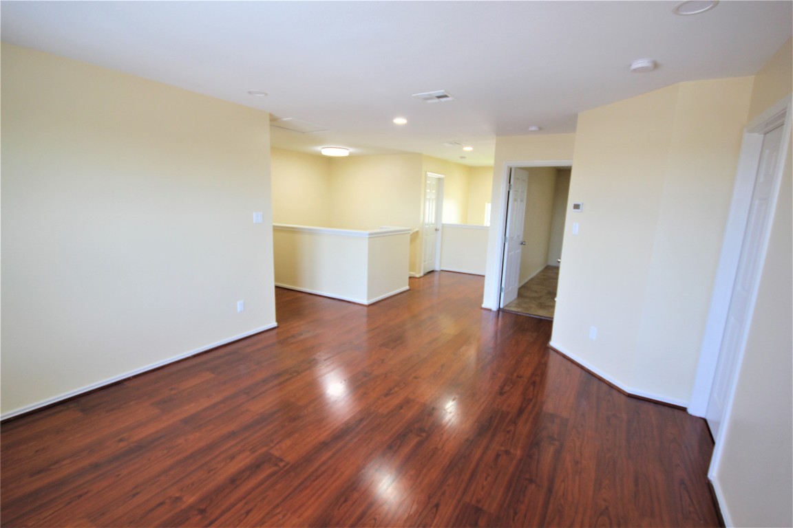 205 Rinehardt Street Hutto, TX 78634 - Photo 31 of 40 a view of empty room with wooden floor