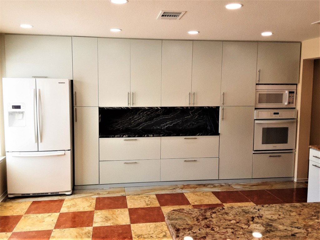 205 Rinehardt Street Hutto, TX 78634 - Photo 9 of 40 a view of a refrigerator in kitchen and a sink