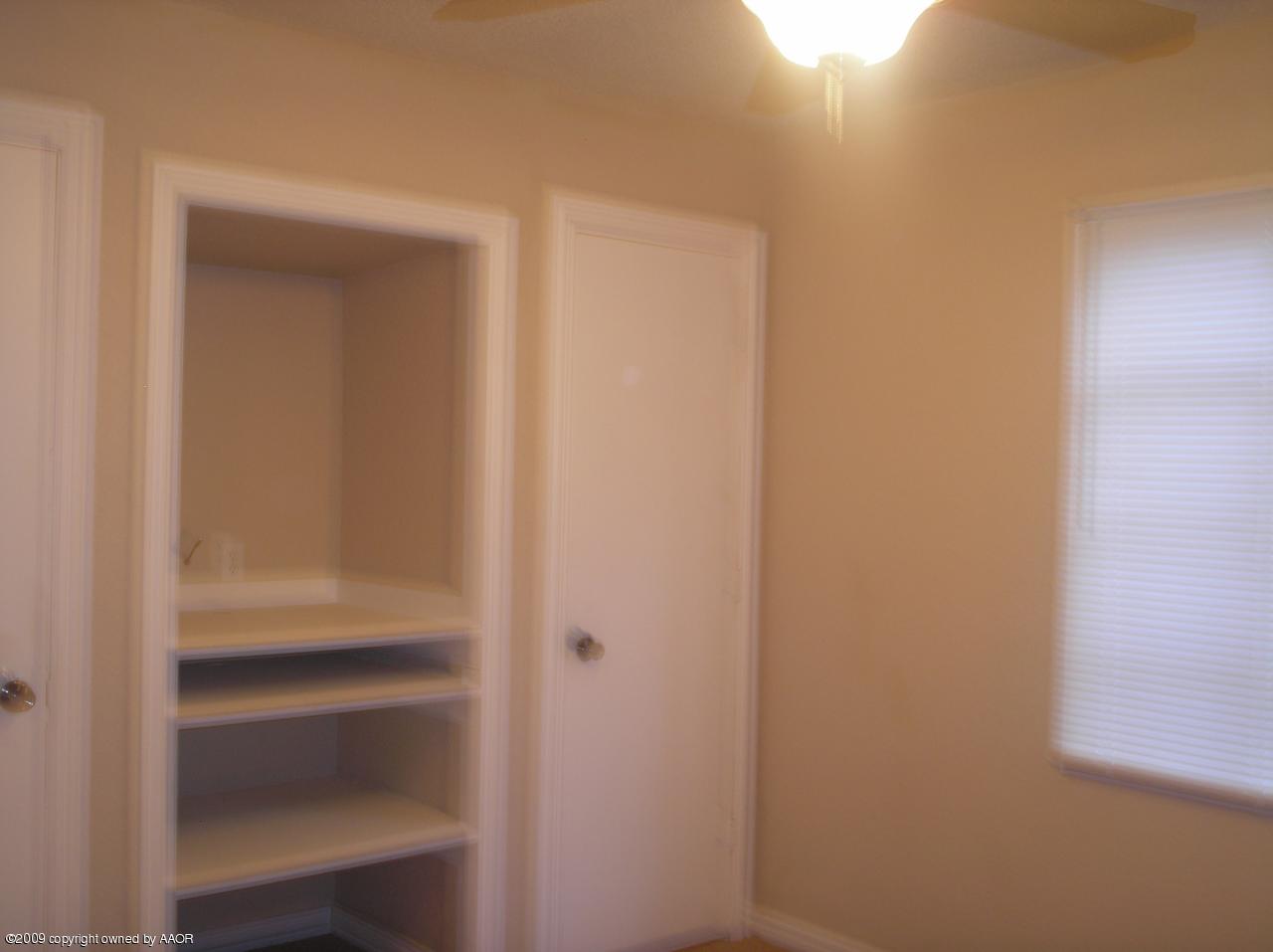 4625 South Ong Street Amarillo, TX 79110 - Photo 11 of 18 a view of walk in closet with empty racks