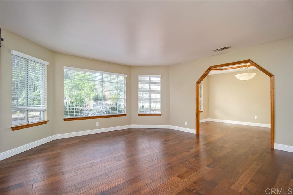 1054 Capra Way Fallbrook, CA 92028 - Photo 4 of 25 Oversized living room with plenty of room for the family piano, or just a great place to enjoy the views of your front yard and the fruit trees!