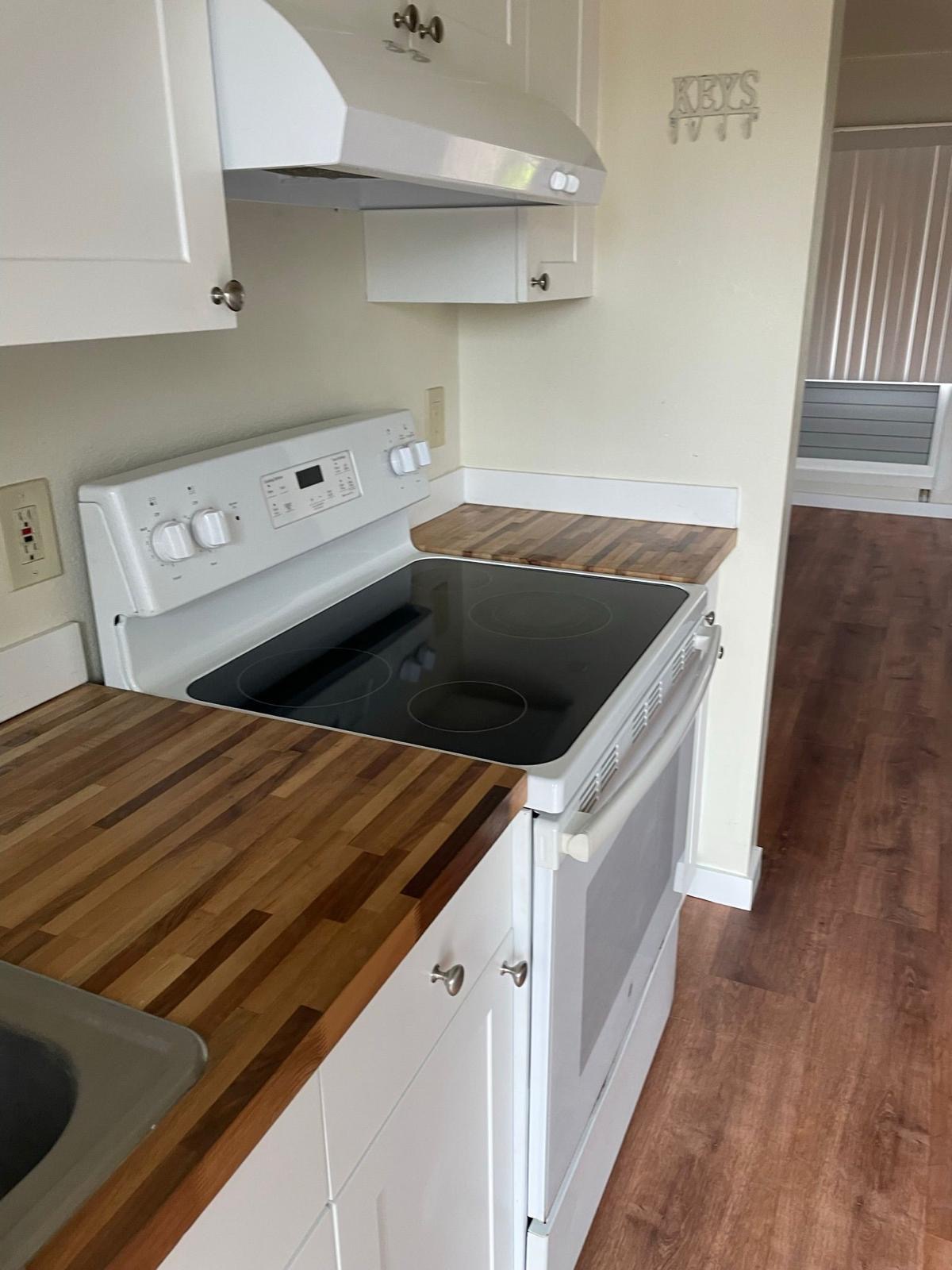 4461 Kamoa Road, Unit D12 Kapaa, HI 96746 - Photo 4 of 13 a stove top oven sitting inside of a kitchen