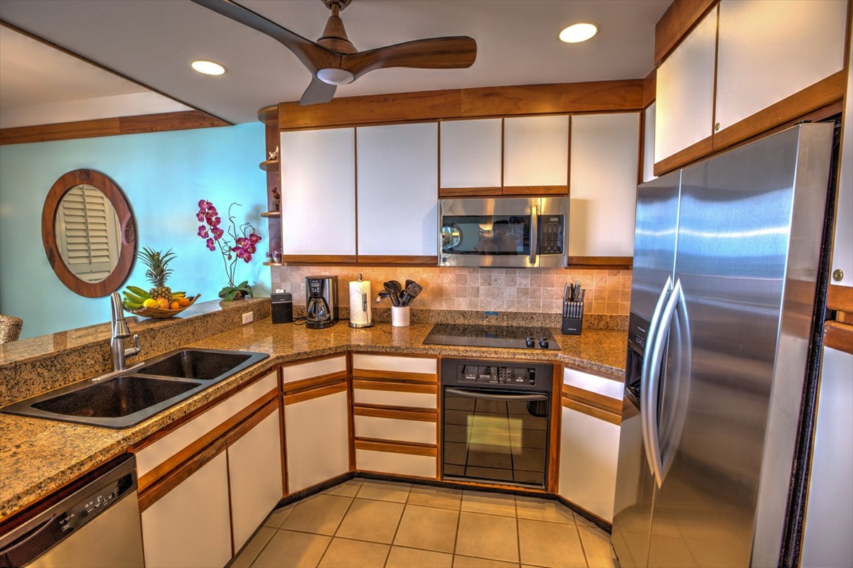 2640 Puuholo Road, Unit 134 Koloa, HI 96756 - Photo 7 of 20 a kitchen with stainless steel appliances granite countertop a sink a stove and a refrigerator