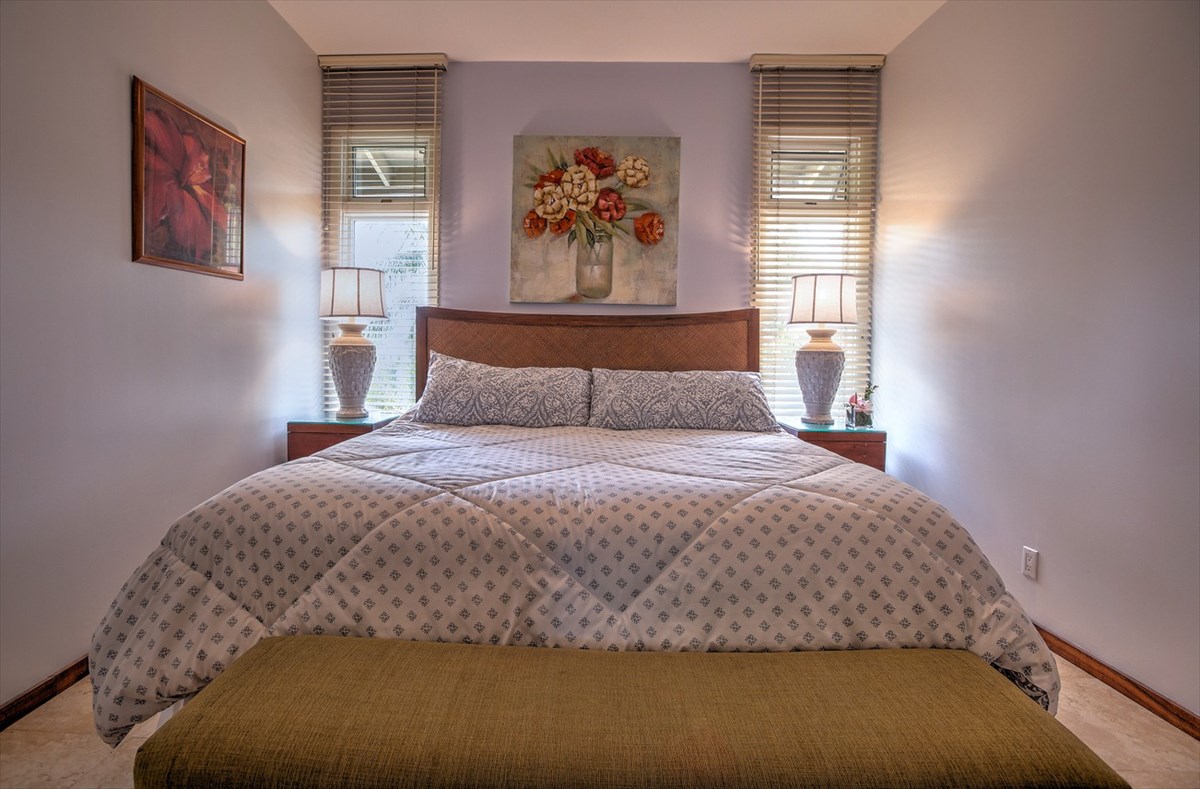 2640 Puuholo Road, Unit 134 Koloa, HI 96756 - Photo 10 of 20 a bedroom with a bed and painting on the wall
