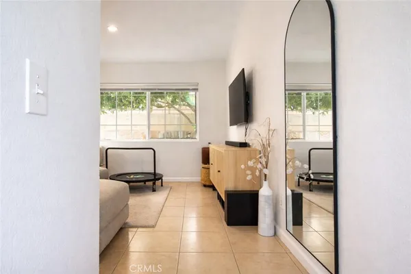 a living room with a flat screen tv and a window